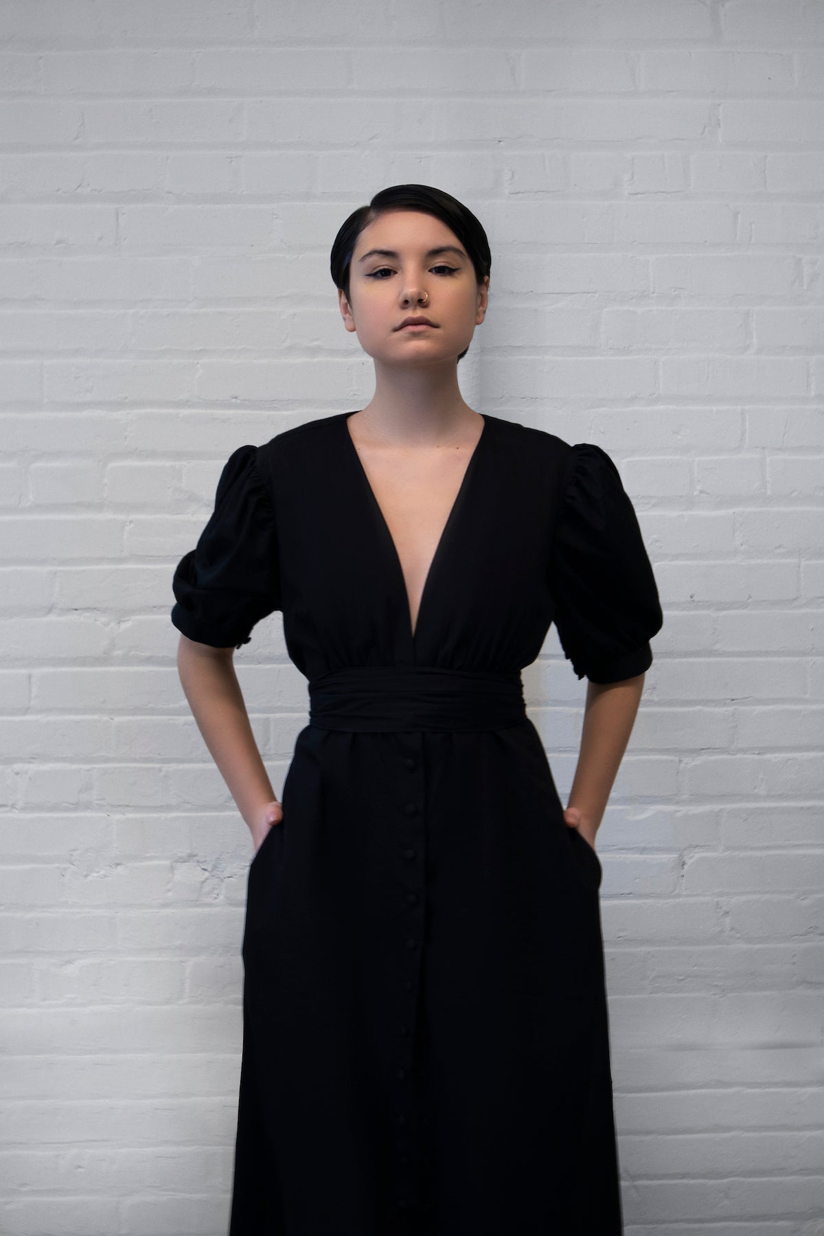 a low v-neck black maxi dress with puff sleeves and snap front closure