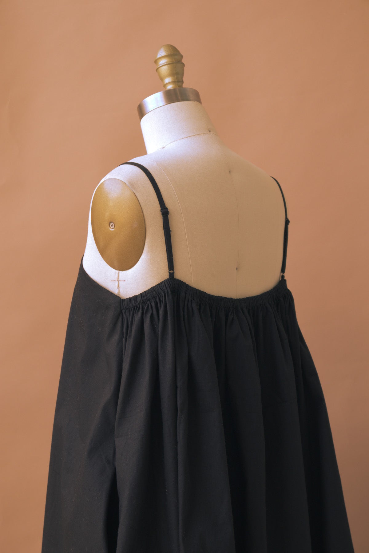 a black flare tent spaghetti strap dress from adrina fanore
